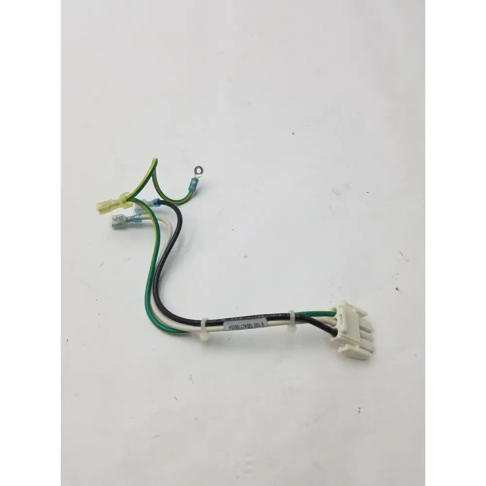 A white plastic 3 pin female connector with green, black, and yellow wires and a label attached to the bundle