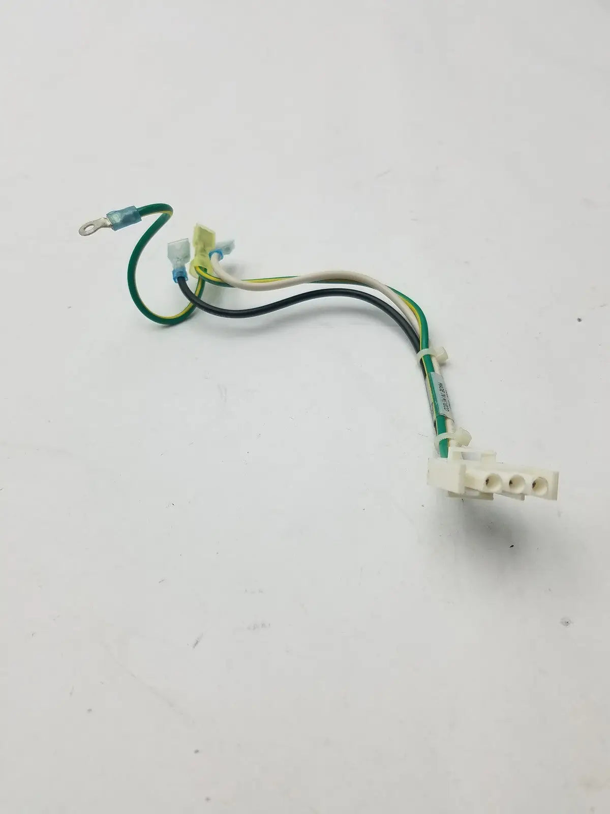 Multi-colored 3 pin female connector with green black and white insulated wires connected to beige plastic housing
