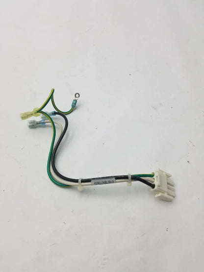 A white plastic 3 pin female connector with green, black, and yellow wires and a label attached to the bundle