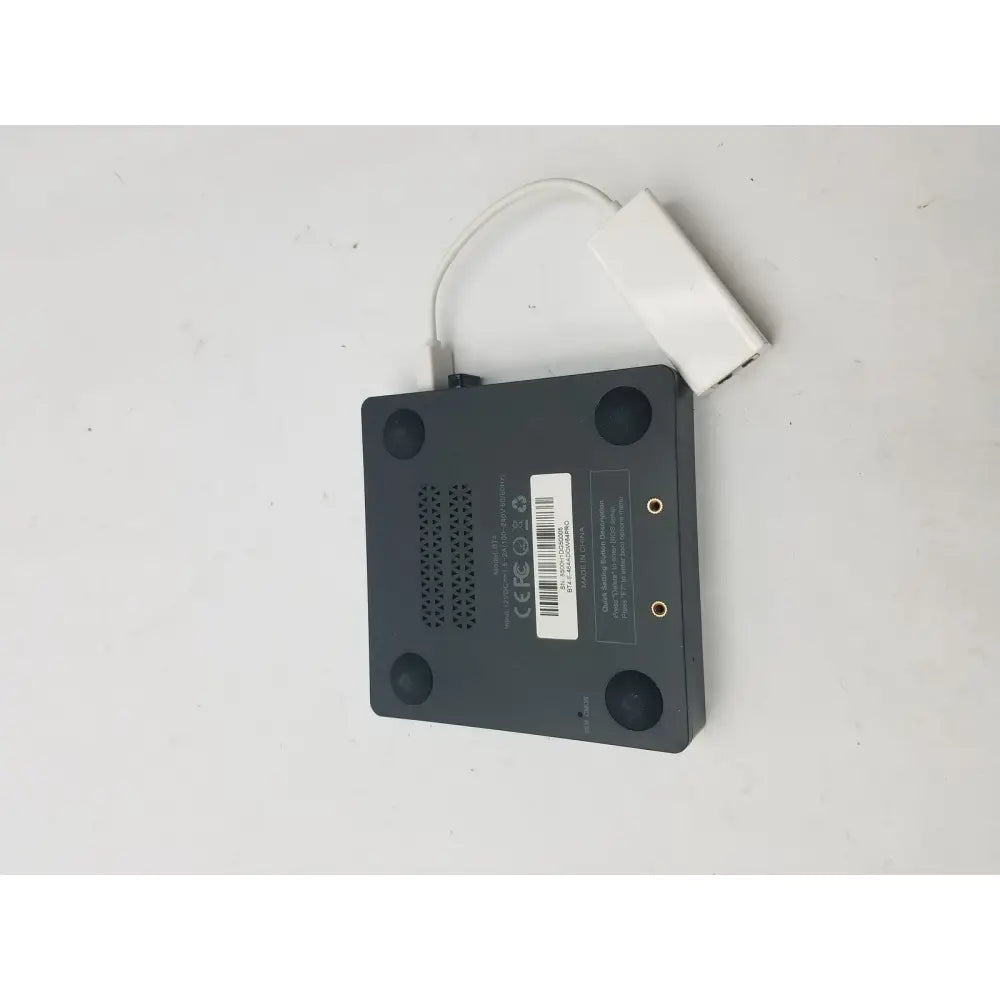 Black rectangular media player with white usb adapter attached by a 3 pin female connector cable for data transfer