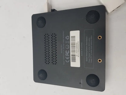 Black rectangular 3 pin female connector cable device with circular feet and ventilation grille shown from back side