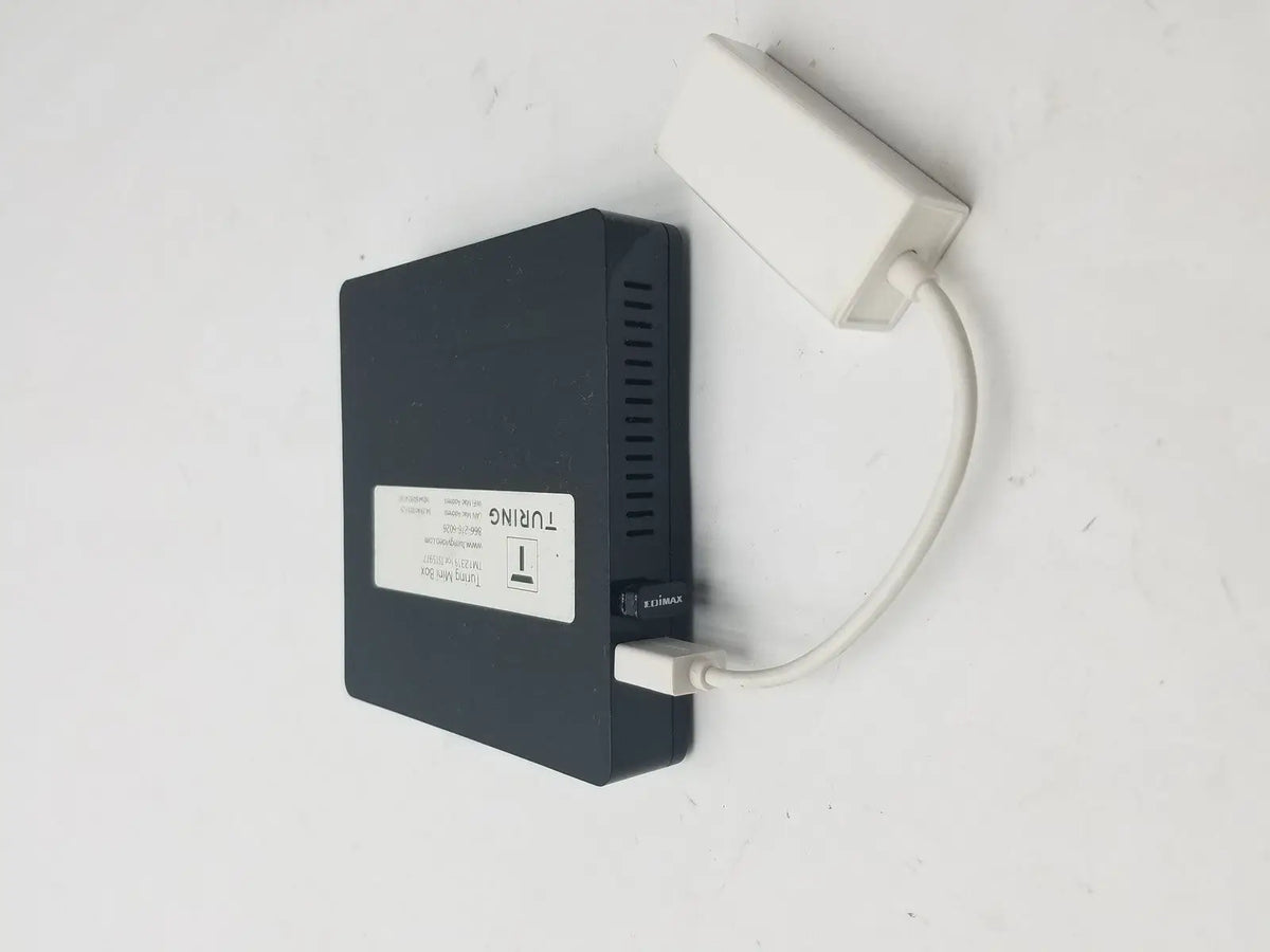 Black rectangular external hard drive connected with white 3 pin female connector cable and power adapter attached