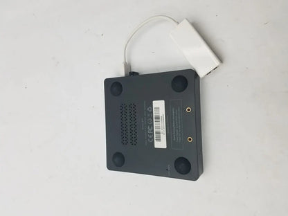 Black rectangular media player with white usb adapter attached by a 3 pin female connector cable for data transfer