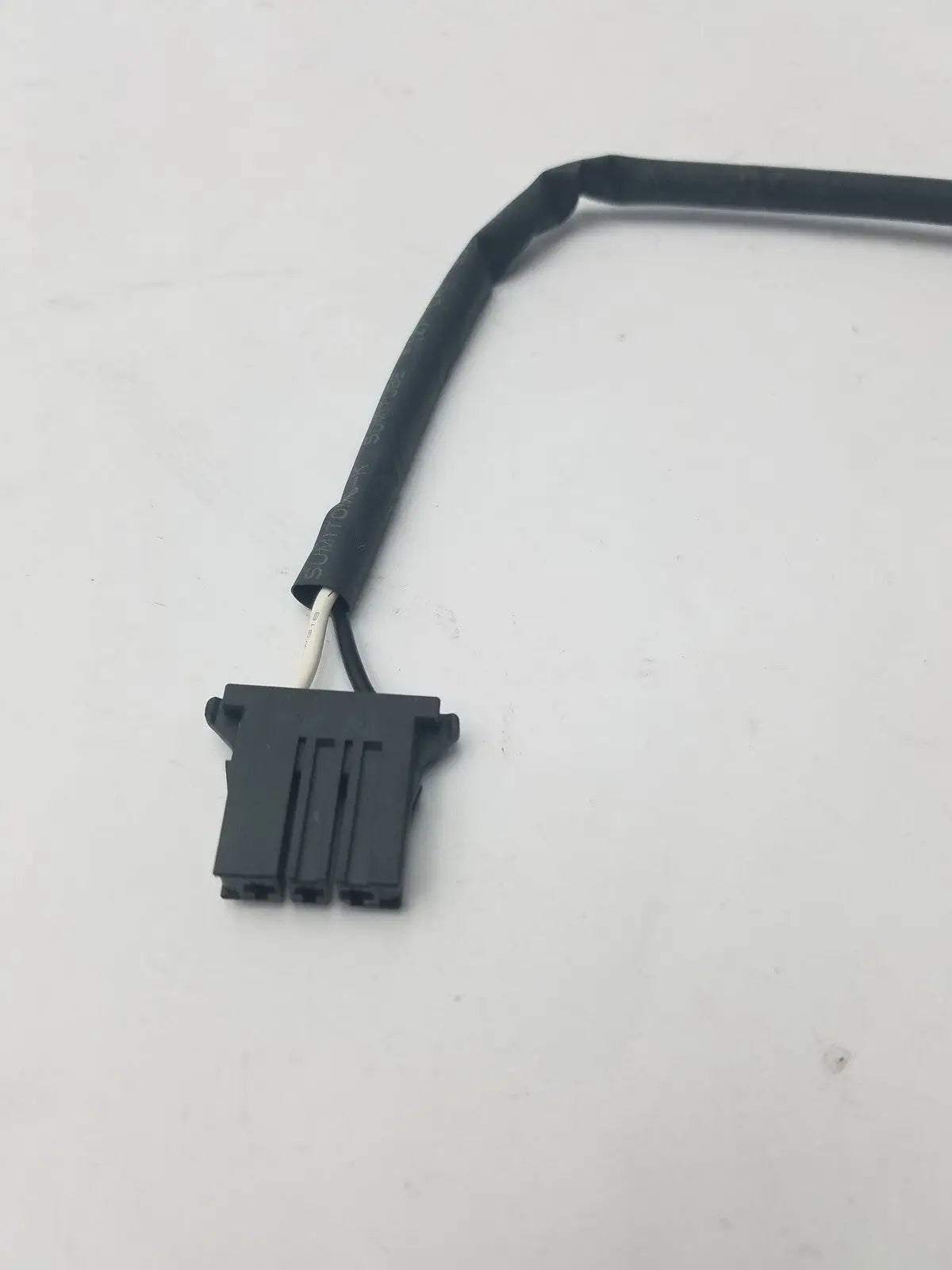 Black plastic 3 pin female connector wire with flexible cable and three visible pins showing white internal wires