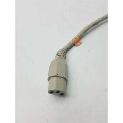 Beige three-prong pin pronge power cord with ribbed strain relief and orange label featuring a pin female connector