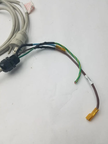A coiled beige 3 prong power cable with a black wire connector harness and multiple colored wires extending from it