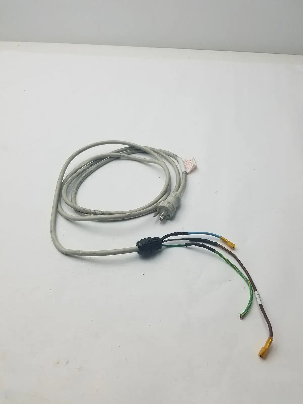 Gray 3 prong power cable with multiple colored wires and black wire connector harness for electrical connections