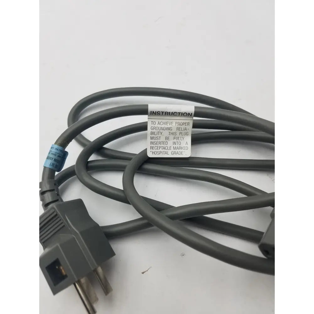 Gray hospital-grade 3 prong power cord detachable cable with instruction label for reliable medical use