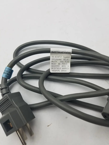 Gray hospital-grade 3 prong power cord detachable cable with instruction label for reliable medical use