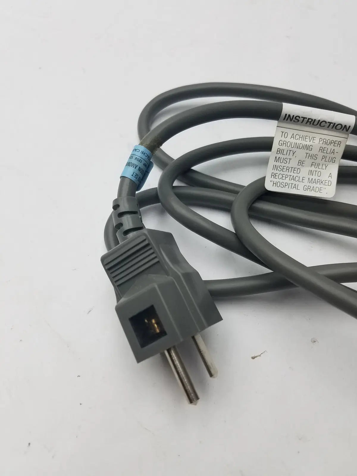 Gray 3 prong power cord detachable cable with instructional label and durable insulated material for secure connections