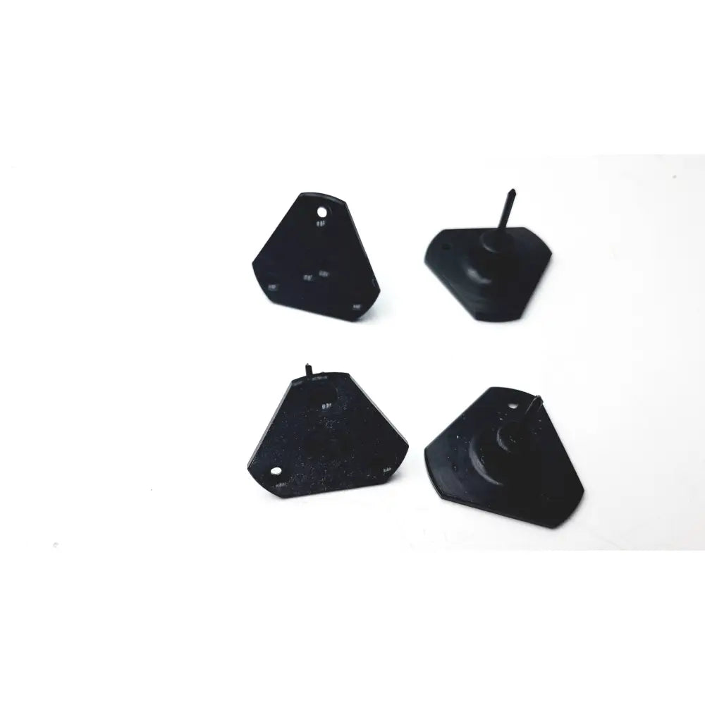 Black plastic triangular wall anchors with textured surface and central screw hole in calibration kit a1146001b for 3 shape scanner