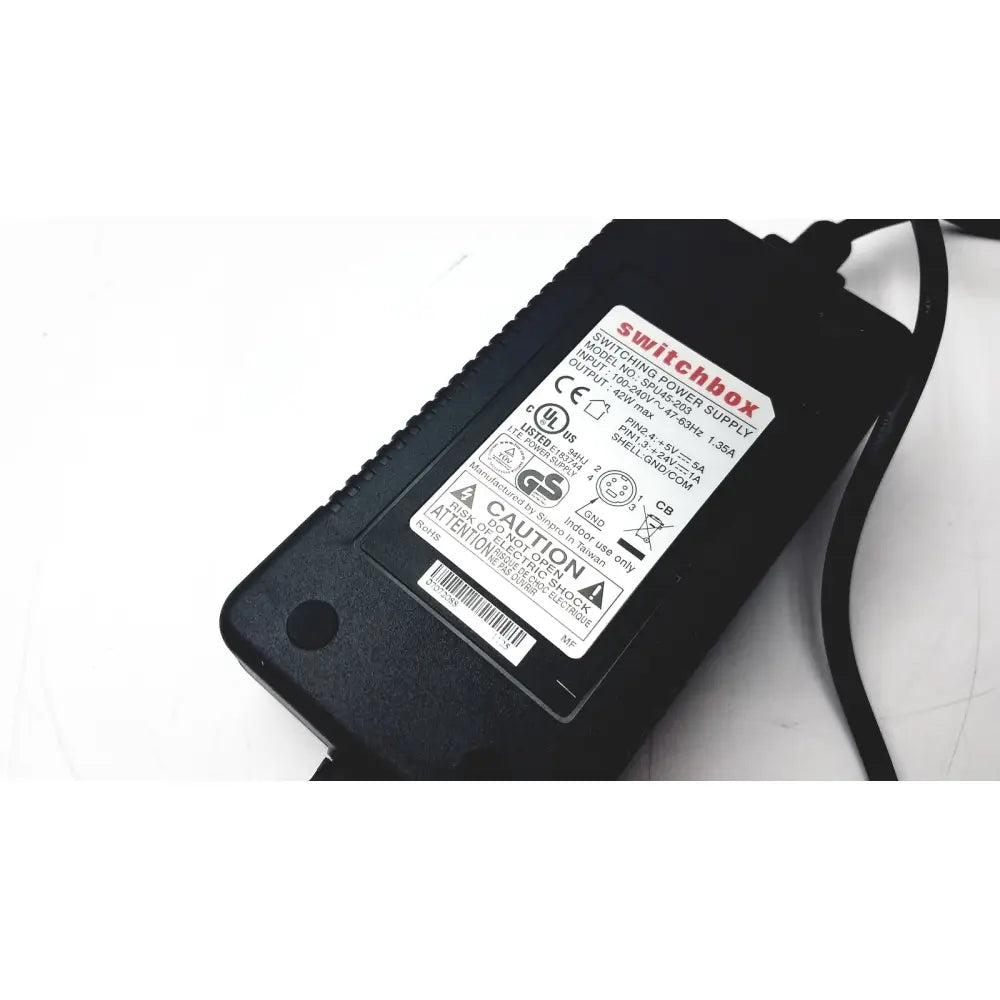 Black plastic switchbox power supply adapter with white label showing specifications for calibration kit a1146001b
