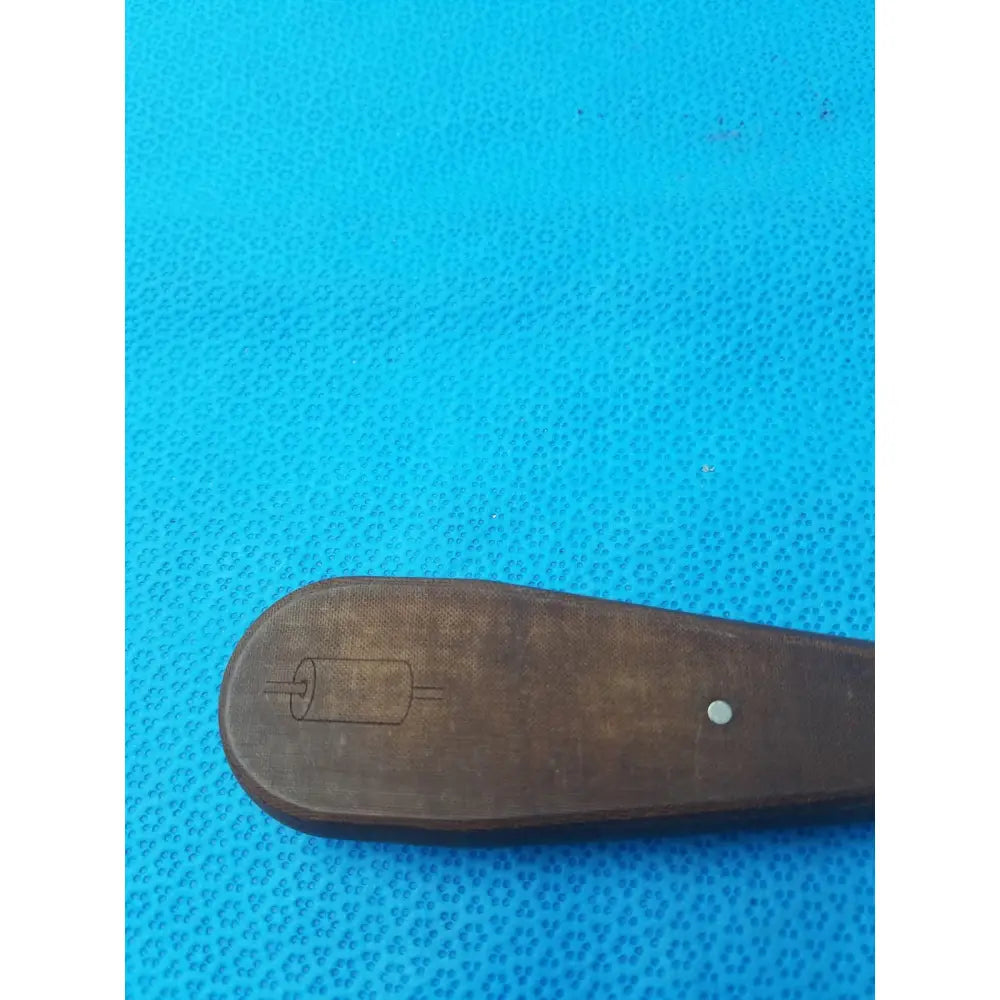 Dark brown wooden handle hex screwdriver stainless steel surgical instrument with carved roll illustration and white dot