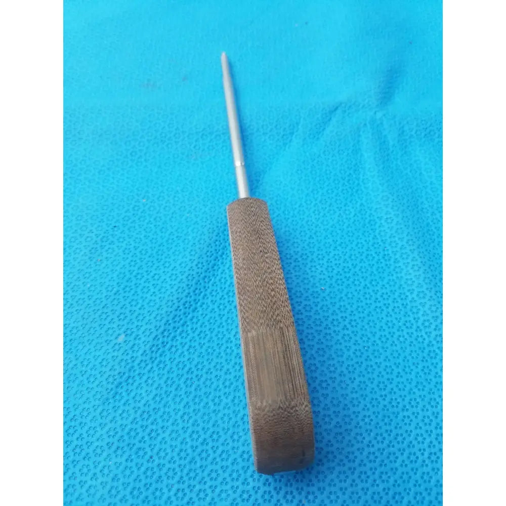 A sleek metallic surgical instrument hex screwdriver stainless steel with a textured bamboo handle and pointed tip