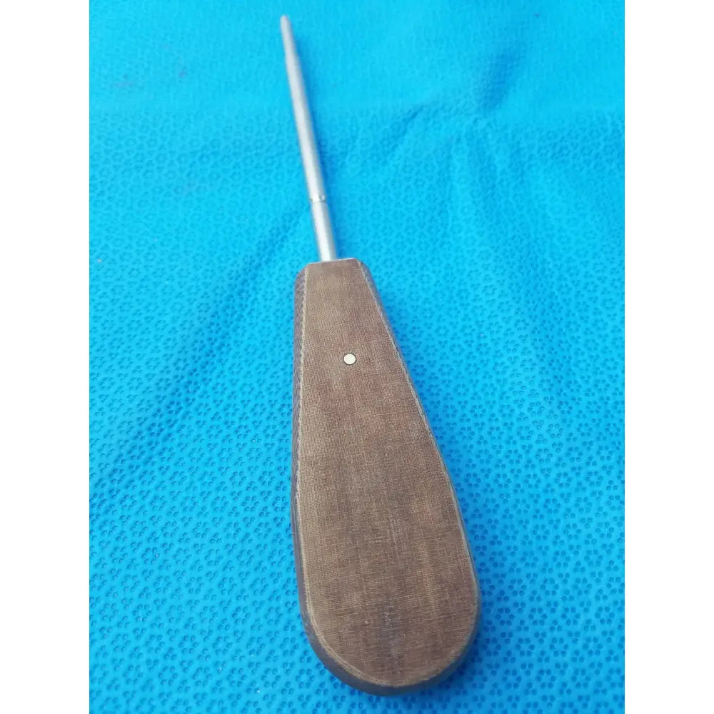 Brown textured handle surgical instrument with slender metallic shaft hex screwdriver stainless steel for precision use