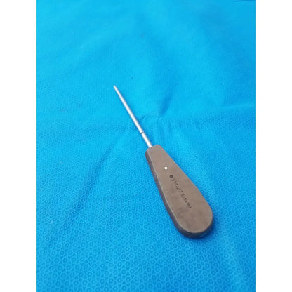 A surgical instrument hex screwdriver stainless steel with polished metallic shaft and brown wooden handle with engravings