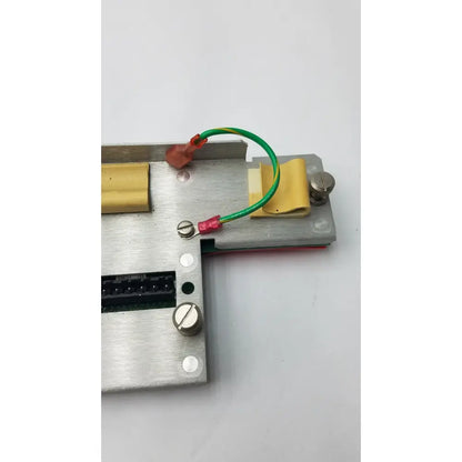 Silver metallic electrical component with green and red wires on the back of rev 7b black 35421222a rev black keyboard