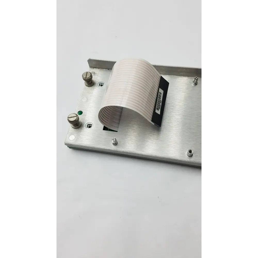 Silver metallic rectangular plate with curved beige ribbon cable attached to the back of 35421222a rev 7b black keyboard