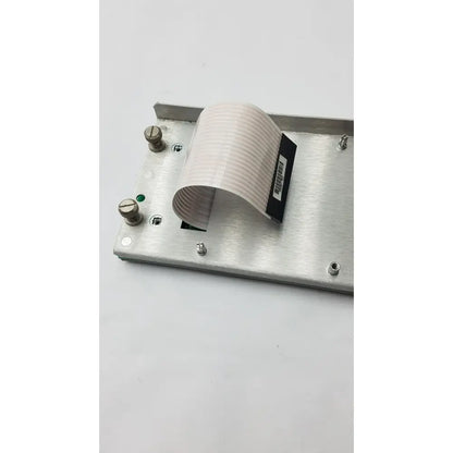 Silver metallic rectangular plate with curved beige ribbon cable attached to the back of 35421222a rev 7b black keyboard
