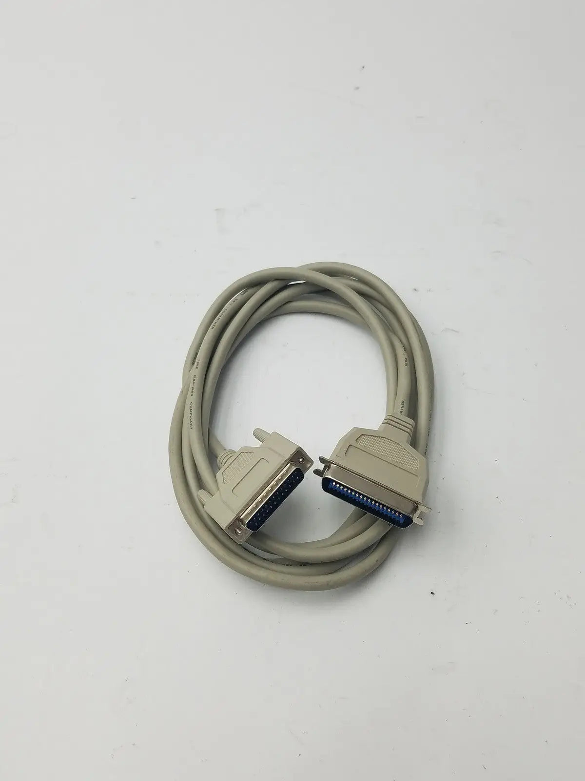 Beige coiled 36-pin male to 25-pin male parallel printer cable with metallic connectors and blue internal contacts for printers