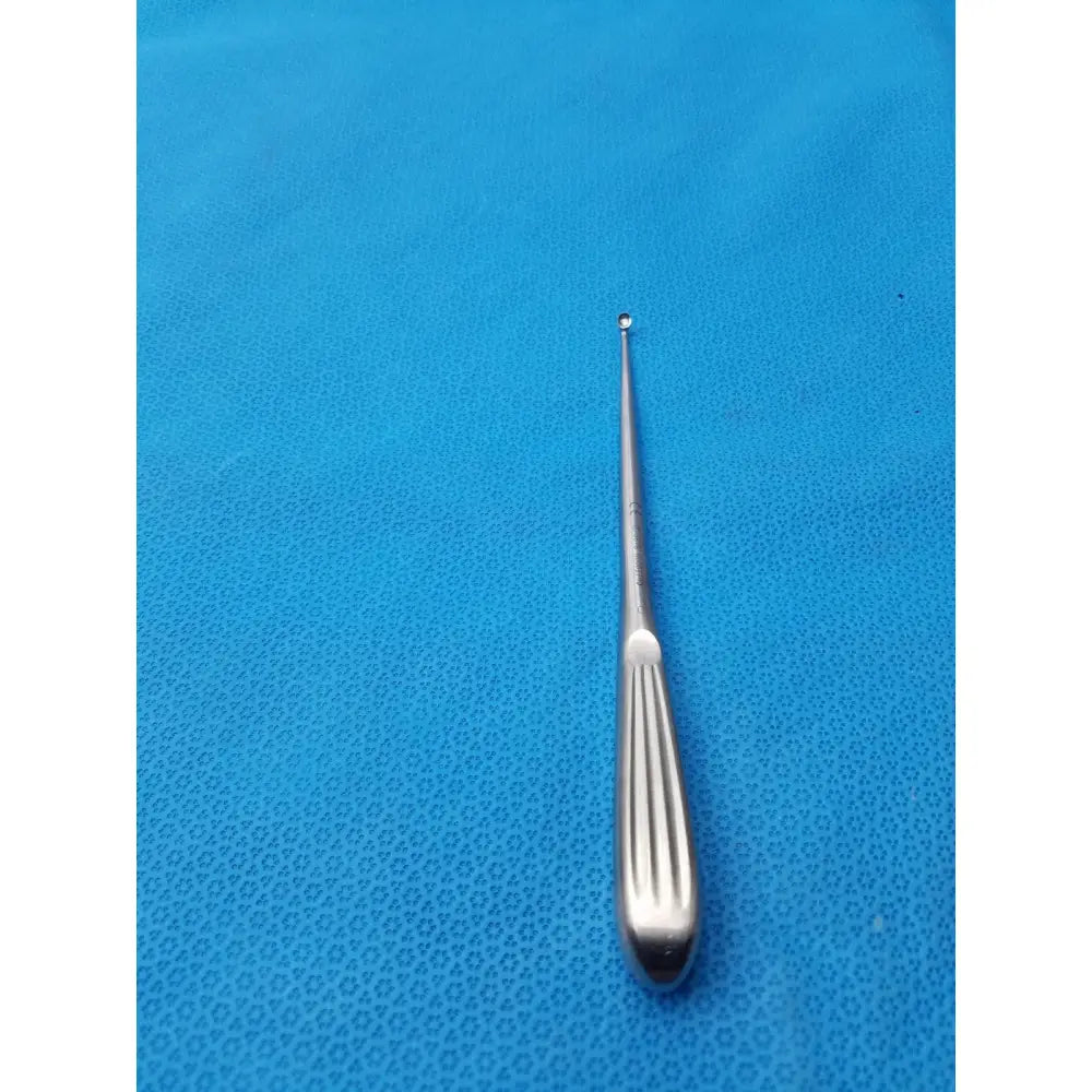 Silver spratt bone curette stainless surgical instrument with slender polished metal shaft and ribbed handle for orthopedic use