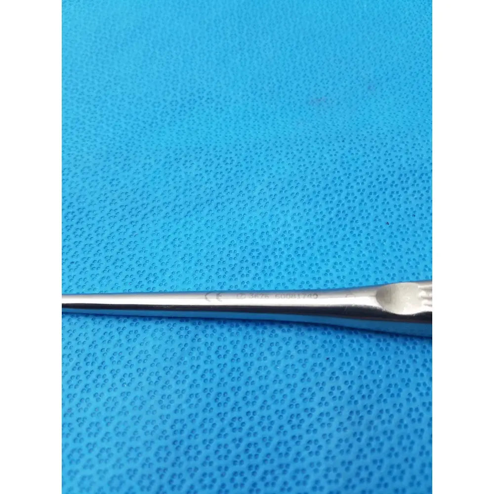 A sleek spratt bone curette stainless surgical instrument with polished stainless steel finish and ergonomic handle