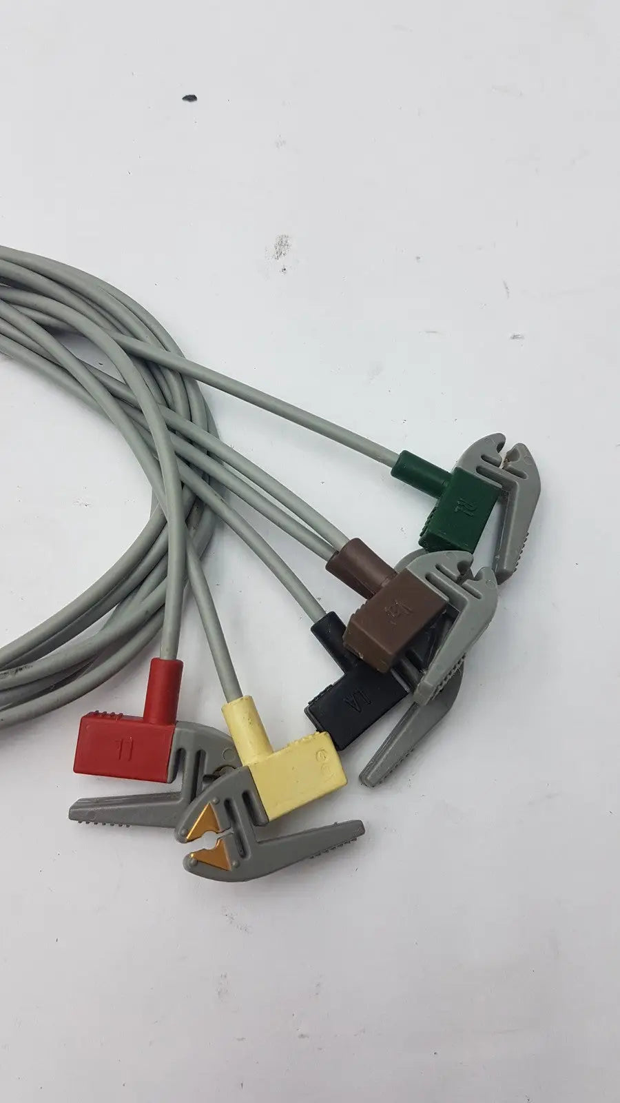 Set of five gray compatible ecg telemetry cables with colorful red yellow green and brown plastic grabber clamps