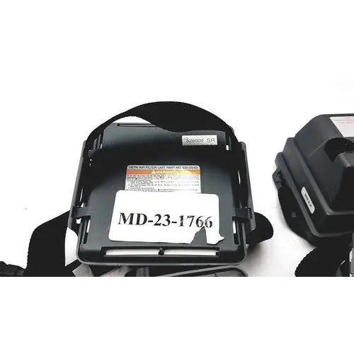 Black plastic headband with white label md-23-1766 and orange warning sticker on 3m 520-03-63 air-mate hepa filter unit battery