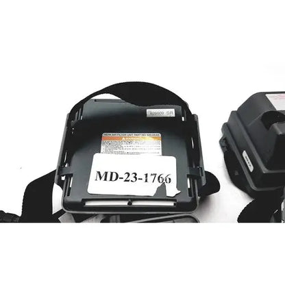 Black plastic headband with white label md-23-1766 and orange warning sticker on 3m 520-03-63 air-mate hepa filter unit battery