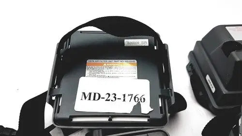 Black plastic headband with white label md-23-1766 and orange warning sticker on 3m 520-03-63 air-mate hepa filter unit battery