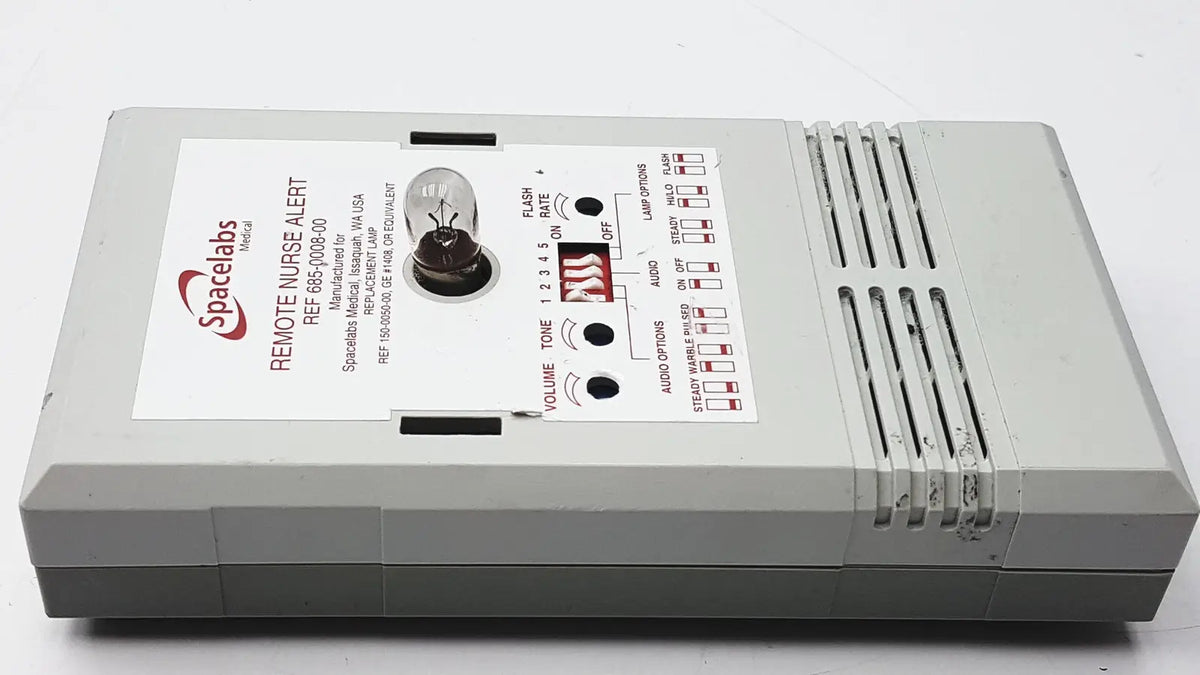 Gray plastic spacelabs remote nurse alert device with control buttons shown alongside 3m 60923 half mask respirator