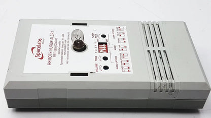 Gray plastic spacelabs remote nurse alert device with control buttons shown alongside 3m 60923 half mask respirator