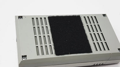 Gray rectangular 3m 60923 half mask respirator back side with black felt pad between vertical slits for filtration efficiency