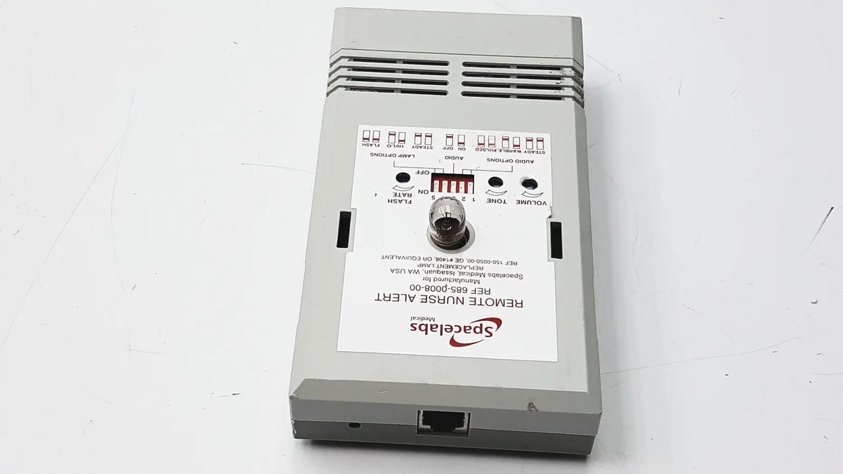 Gray rectangular electronic device with spaceslabs logo labeled remote nurse alert shown with 3m 60923 half mask respirator