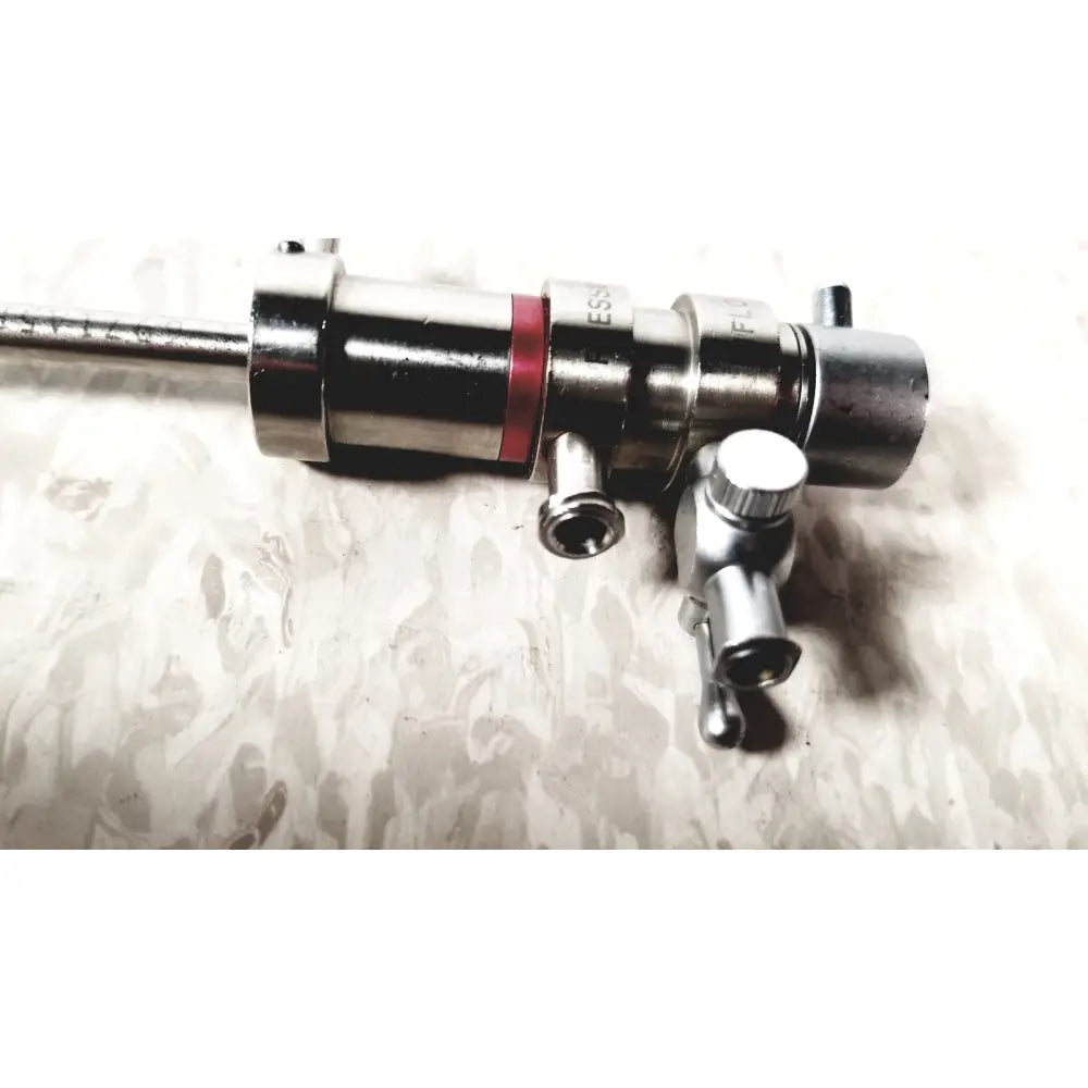 Silver metallic 3M 83272 pressure dispensing cannula with red band and multiple ports featuring rotating stopcocks