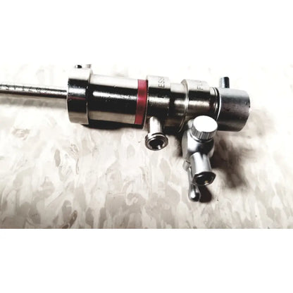 Silver metallic 3M 83272 pressure dispensing cannula with red band and multiple ports featuring rotating stopcocks
