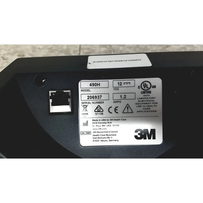 Black 3m attest auto-reader 490h incubator showing electrical equipment with silver label of specifications and certification marks