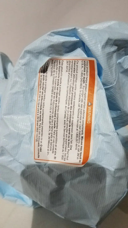 Blue plastic bag with orange warning label containing 3M BE-12LB blue respirator headcover for PAPR systems
