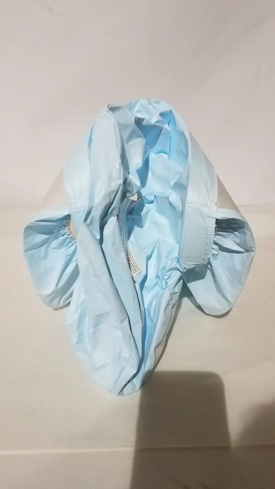 Light blue crinkled plastic raincoat with elasticated cuffs and zipper closure for 3m be-12lb blue respirator headcover