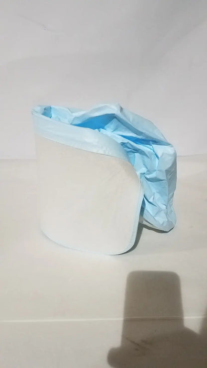 A crumpled light blue be-12lb blue respirator headcover draped over a white cylindrical object for PAPR systems