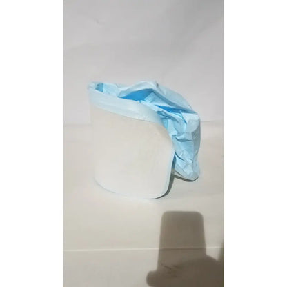A crumpled light blue be-12lb blue respirator headcover draped over a white cylindrical object for PAPR systems