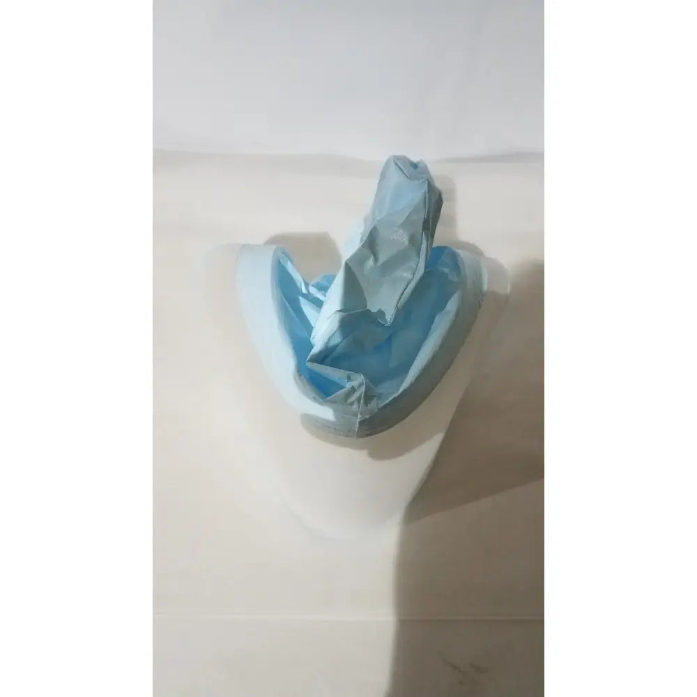 A crumpled light blue plastic be-12lb blue respirator headcover inside a white curved container for PAPR systems