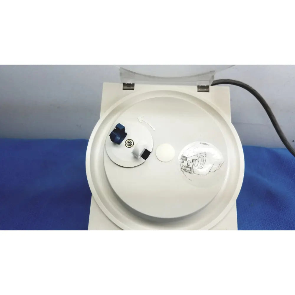 White plastic 3m espe rotomix capsule mixing unit 120v with blue black control knob and circular rotor chamber