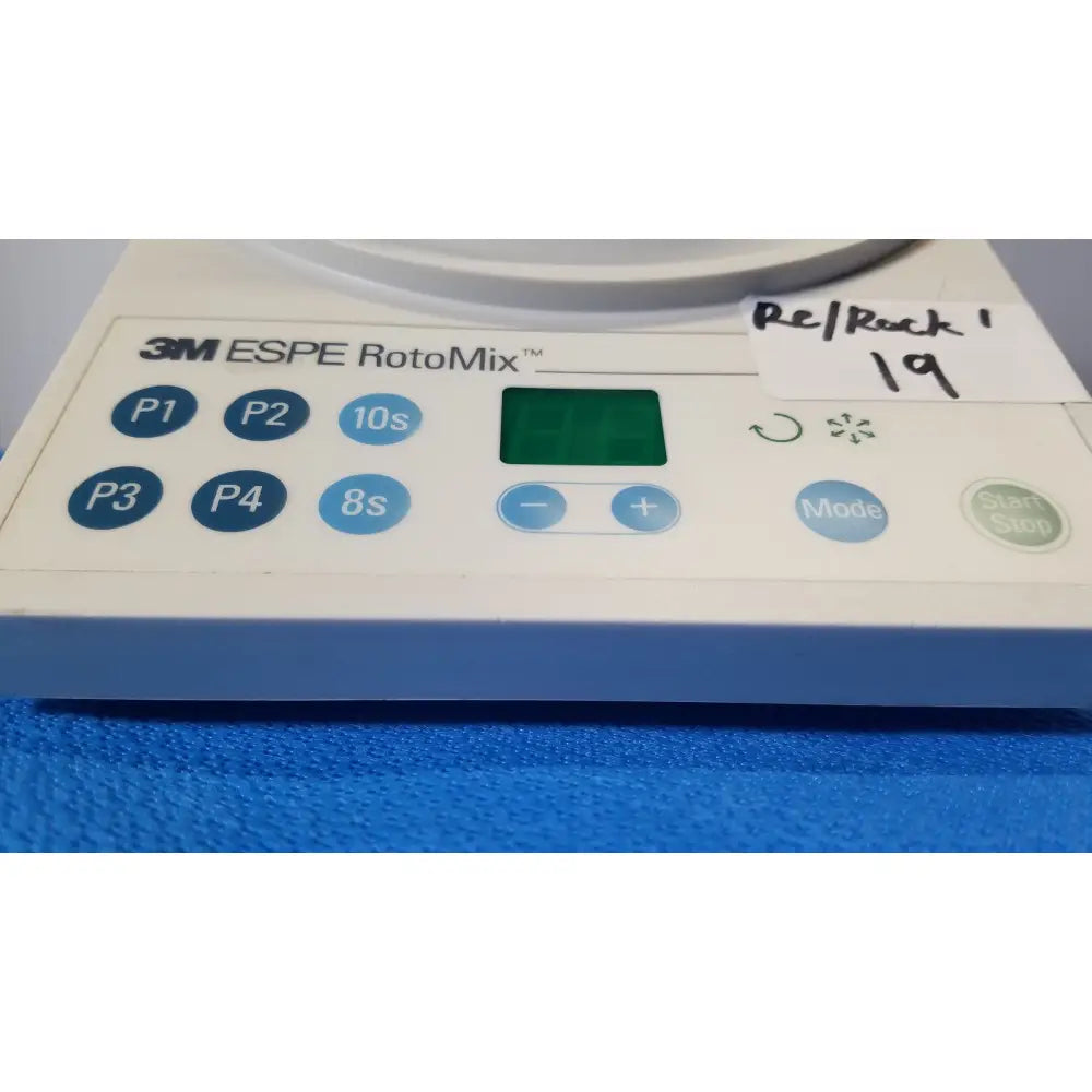 White and blue 3m espe rotomix rotating mixing device with digital display and program buttons for dental use