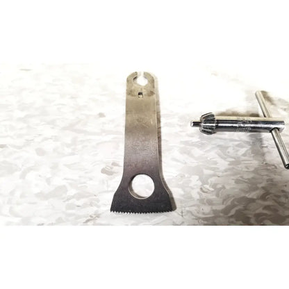 Silver metal bicycle chain tool with serrated edge and circular cutouts in 3m maxi driver ii autoclave tray air set