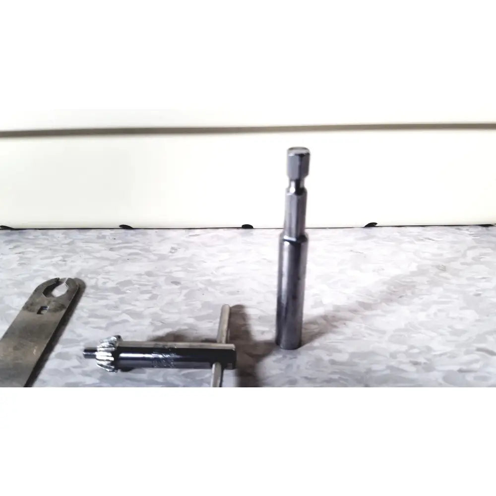 A sleek metallic socket wrench with hexagonal drive head and polished chrome finish for 3m driver ii autoclave tray air set