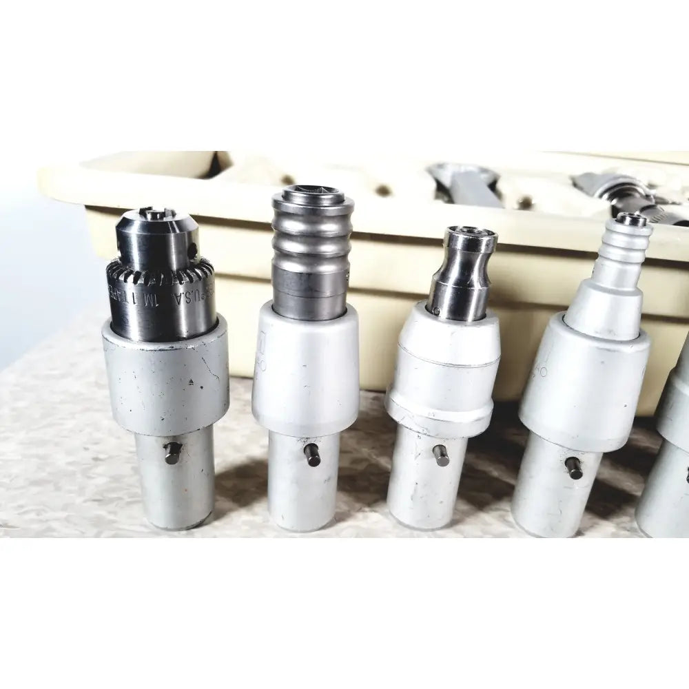 Silver and chrome dental driver ii autoclave handpieces with threaded tops in 3m maxi driver ii autoclave tray air set