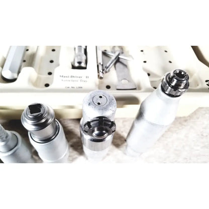 Silver 3M Maxi driver ii autoclave tray air powered dental handpieces with black grips in white tray labeled maxi-drive ii autochave tray