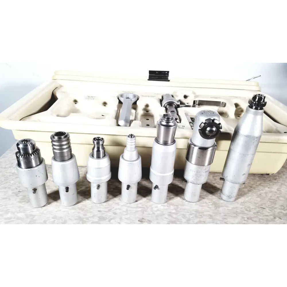 Set of seven silver metal 3m maxi driver ii autoclave tray air powered handpieces with attachments and beige case