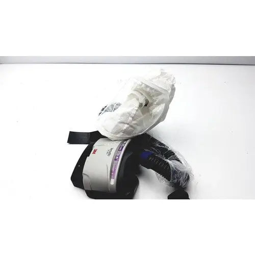 3m papr versaflo blower mx2169225 respirator mask with black straps gray housing partially wrapped in clear plastic